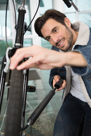 man inflating his bicycle tireの写真素材