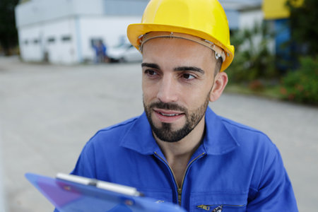 contractor on construction site using electronic tabletの写真素材