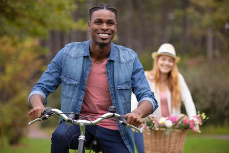 young couple cycling in countrysideの写真素材