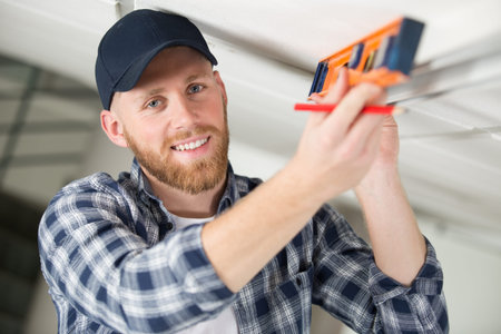 builder checking work with spirit level