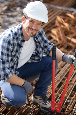 construction worker at construction site assembling falsework