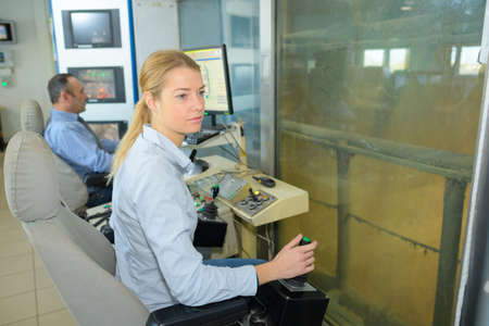 operatives using levers on electronics controlsの写真素材