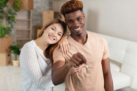 young couple showing key from their houseの写真素材