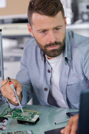 a man is fixing the chip