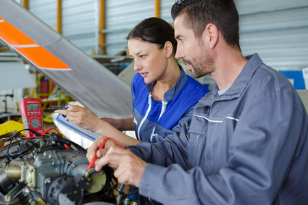 man and woman mechanics baffled work