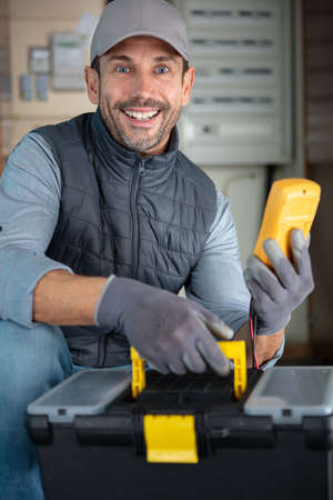 handsome electrician wiring cables at siteの写真素材