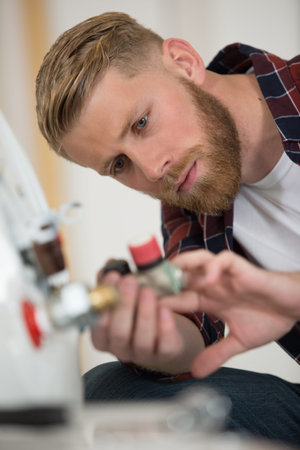 man during installation of gas boiler