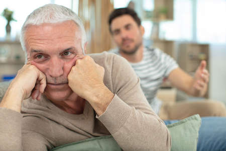 two men in living room have had an argumentの写真素材