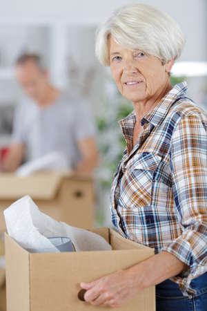 a cheerful woman moving housesの写真素材