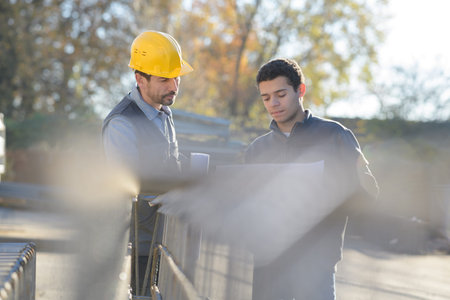 two workers in a uniform and hardhat