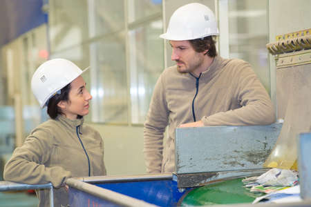 engineers standing in recycling plantの写真素材