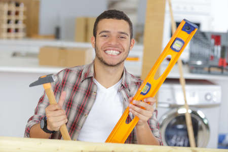 a smiling worker holding toolsの写真素材