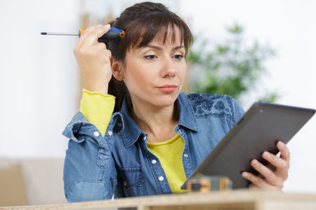 a woman assembling a furniture