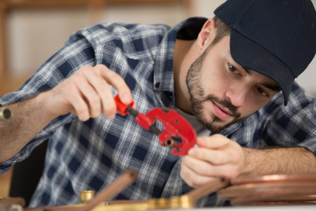 a cooper worler during pipes cutting
