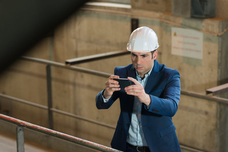 manager taking picture using his cellular phone
