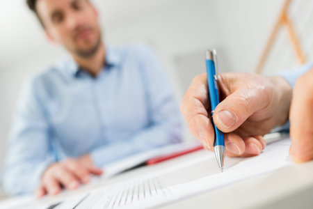 close-up of businessperson signing contract