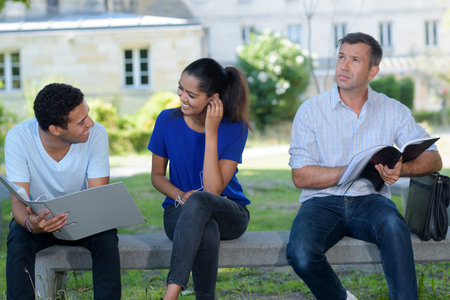 people sat on bench in university campus