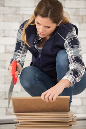 woman cutting woodの写真素材
