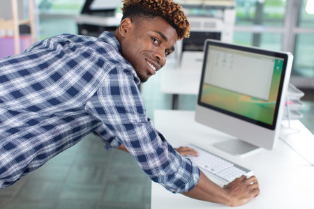 happy young man working with a computer