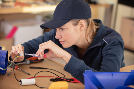 female electrician checking a fuseboxの写真素材