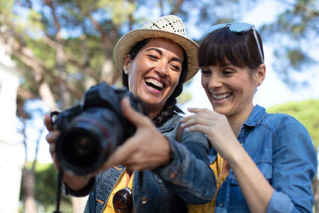 two best friends taking photos while travelingの写真素材