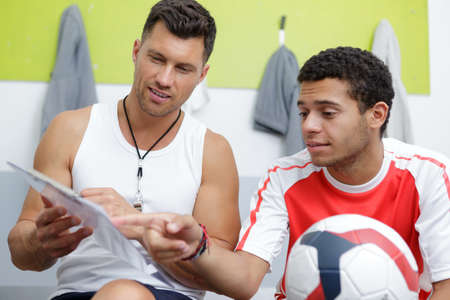 professional trainer and coach in the locker roomの写真素材