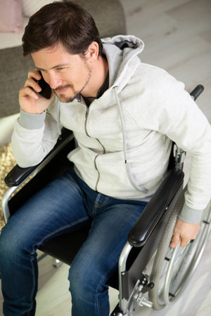disabled man of middle age on the phoneの写真素材