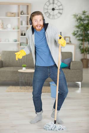 man dancing while mopping the floorの写真素材