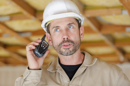 men with a walkie-talkie and a helmet