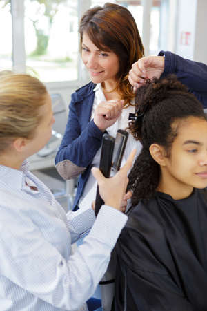 teacher talking to students while hairdresser testの写真素材