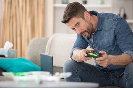 a man drives a toy drone with a remote control