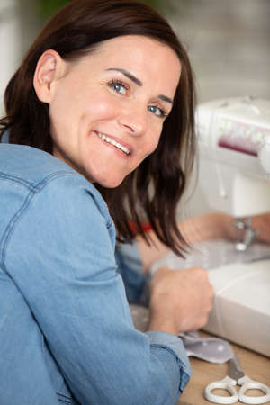 woman sewing with sewing machineの写真素材