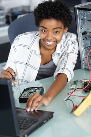 young happy woman fix pc component in service centerの写真素材