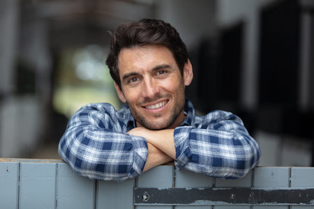 portrait of male farmer standing at stable outdoor