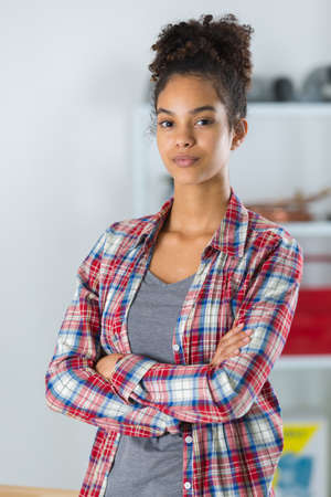 young woman posing in a workshopの写真素材