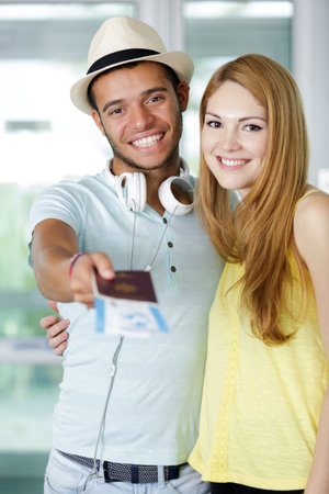 a couple giving passport