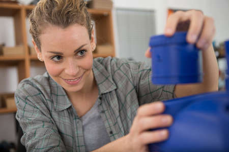 woman assembling plastic componentsの写真素材