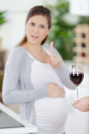 pregnant woman rejecting alcohol at homeの写真素材