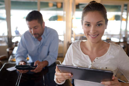 female restaurant manager holding tabletの写真素材