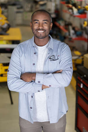 happy man posing with crossed armsの写真素材