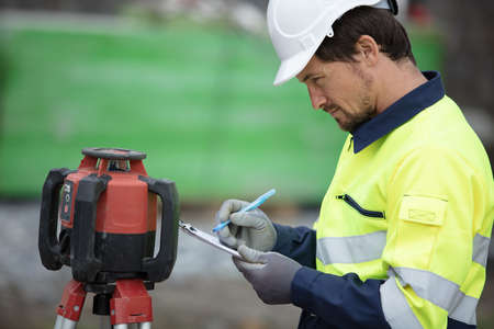 land surveyor at work on construction siteの写真素材