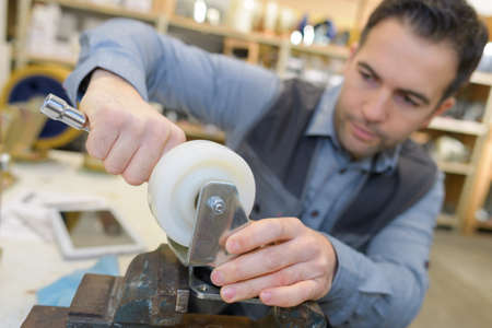 engineer working on wheel of cartの写真素材