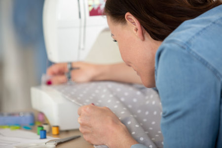dressmaker woman working with sewing machine