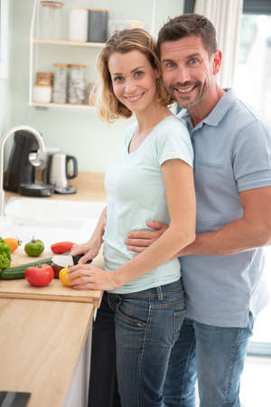 in love couple in the kitchen togetherの写真素材