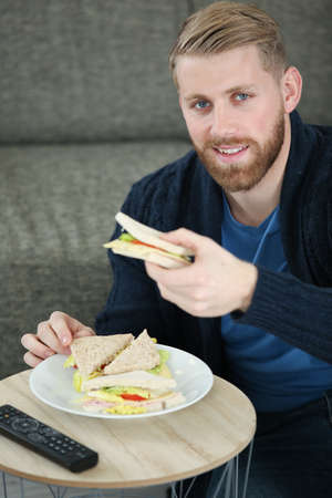 man having a tv lunchの写真素材