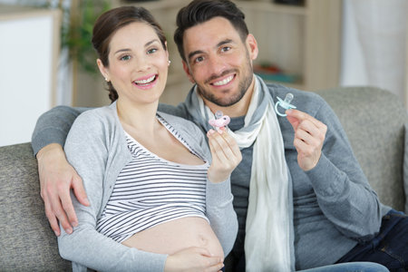 happy couple holding baby accessoriesの写真素材
