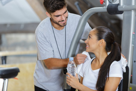attractive young sports people talking in the gym