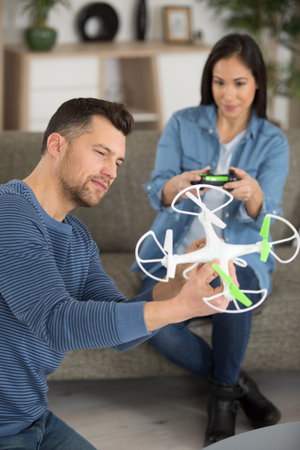 a couple playing with a small quadrocopter drone