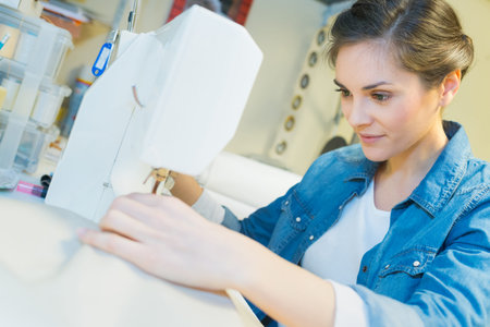 a woman using sewing machine