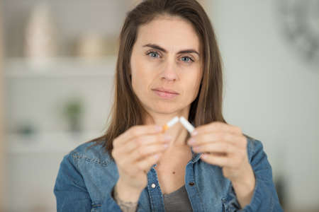 beautiful woman breaks a cigaretteの写真素材